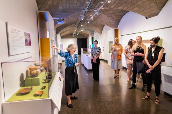 Katherine Moore (left) shows vessels for storing and serving food from Pachacámac at the exhibit.