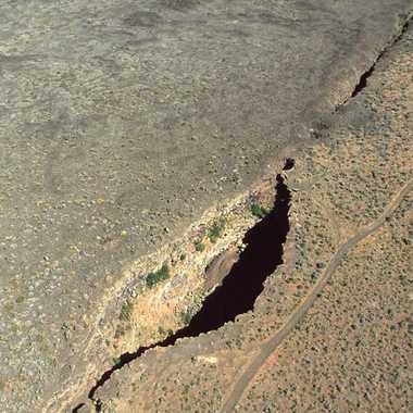 Kings Bowl and Great Rift from air. King's Bowl is a phreatic explosion pit 280 feet (90 m) long, 100 feet (30 m) wide, and 100 feet (30 m) deep, caused by lava meeting groundwater and producing a steam explosion 2,200 years ago. (Wikimedia Commons)